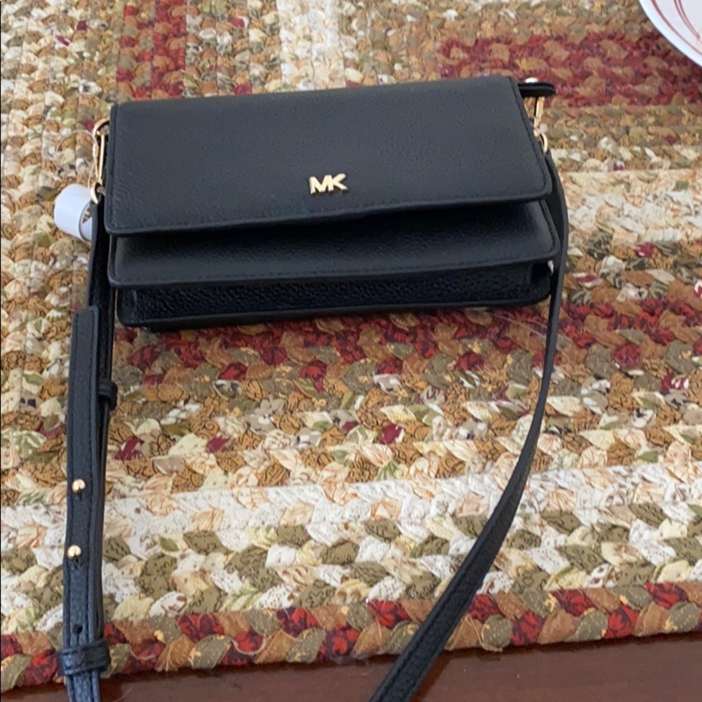 Michal Kors crossbody phone case with card slots.